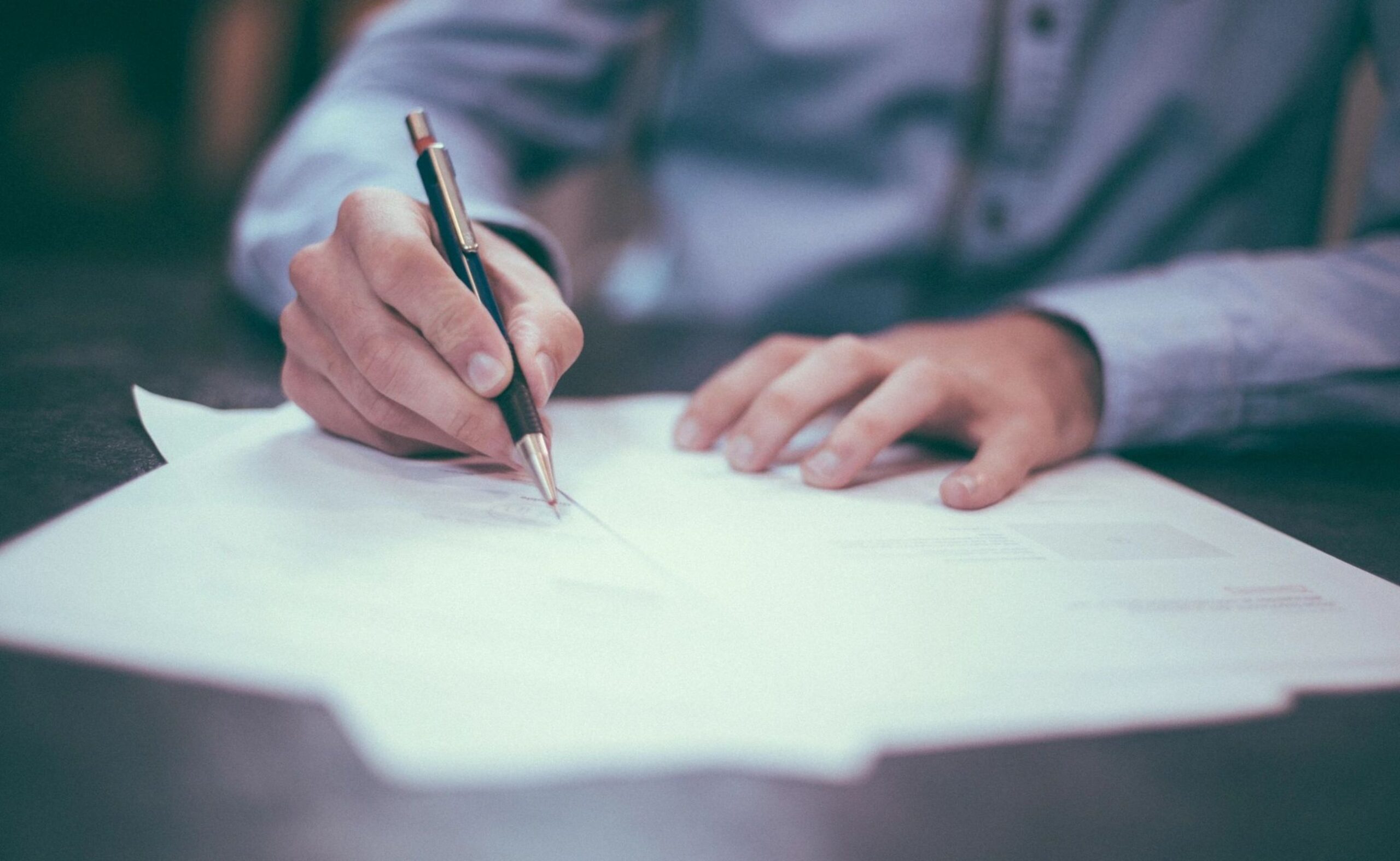 Young man signing paperwork