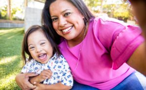 Mother and son with down syndrome smile for the camera