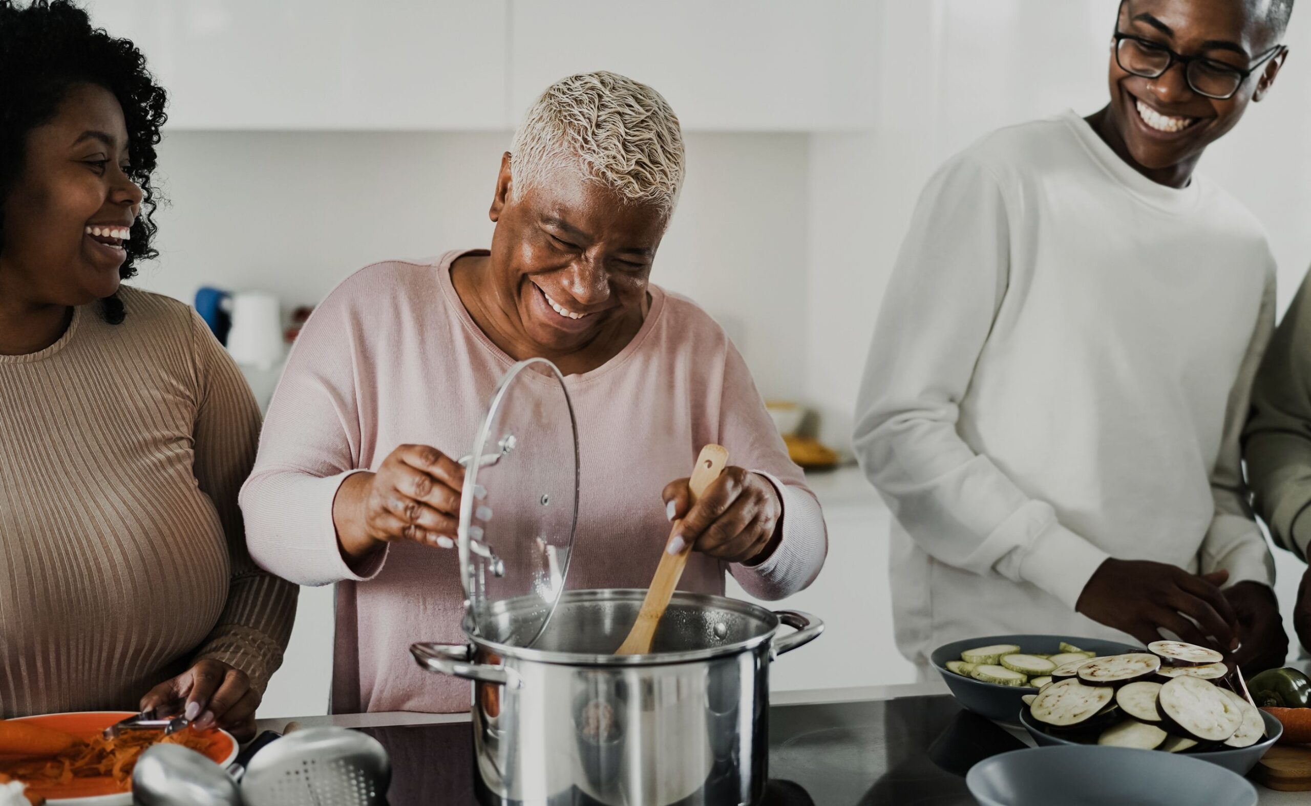 a black family cooking together in the kitchen